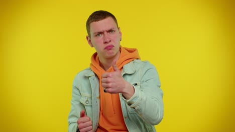 Teen-stylish-man-in-denim-jacket-showing-thumbs-up-and-nodding-in-approval,-successful-good-work