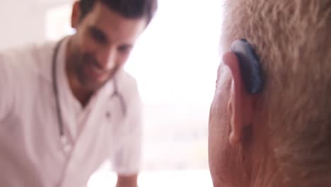 Male doctor and senior man interacting with each other
