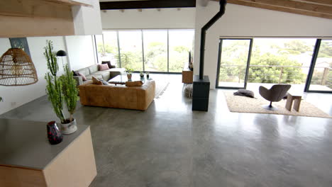 modern living room with large windows, cozy seating area, and stylish decor