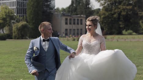 newlyweds. caucasian groom with bride in the park. wedding couple. happy family