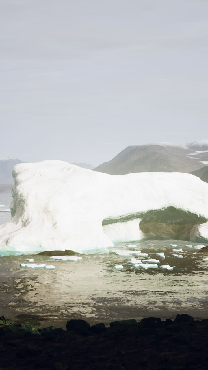 거대한 빙산 이 눈 인 산맥 앞 에 서 있다