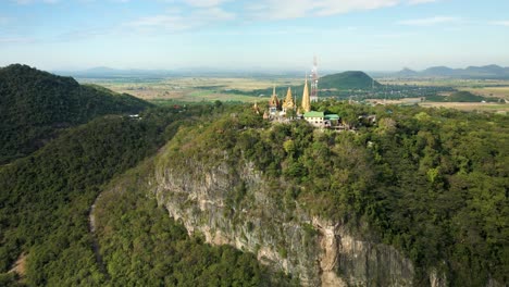 Phnom-Sampov,-golden-buddhist-pagoda-on-cliff-face-in-Battambang,-Cambodia