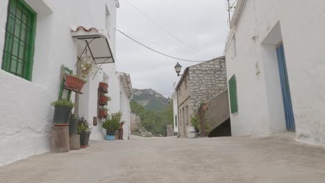 travelling of an uninhabited village in andalusia with white houses and the mountains in the background