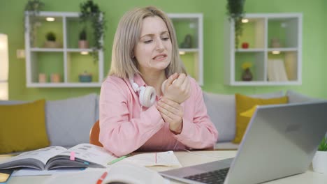 University-student-girl-experiencing-wrist-pain-while-using-laptop.
