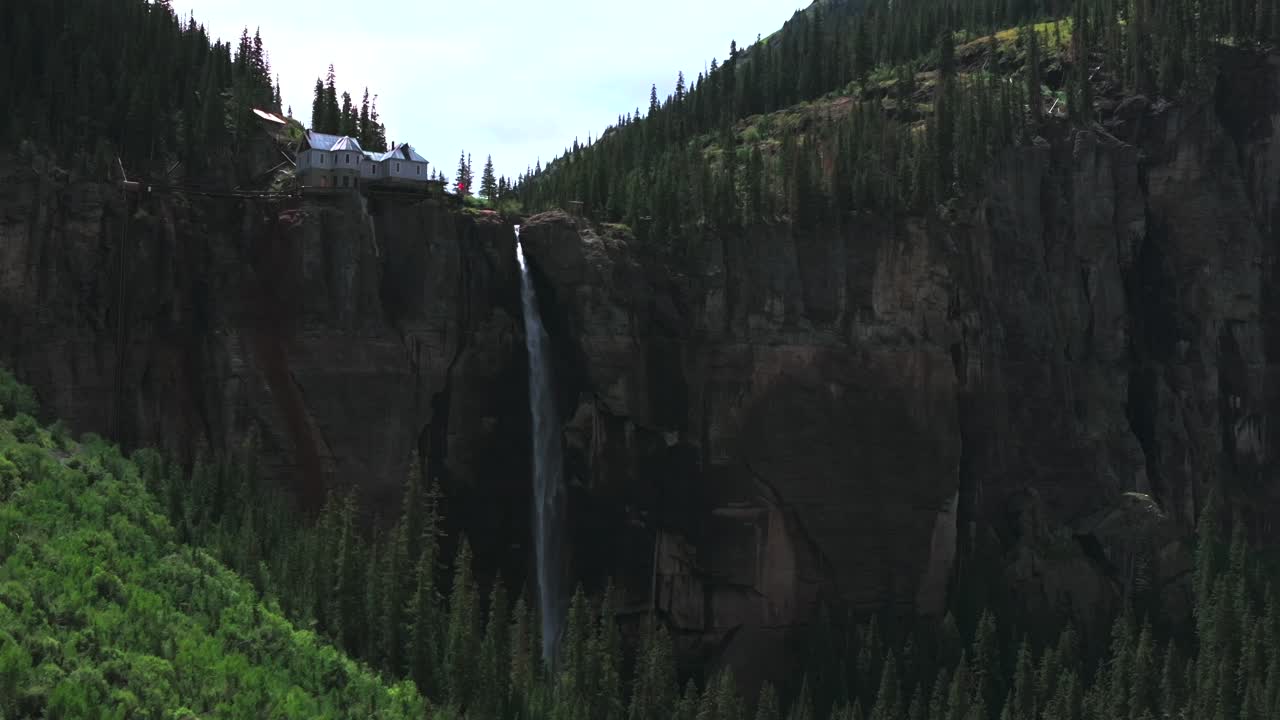 Bridal Veil Falls and Cliffside House in the Rocky Mountains