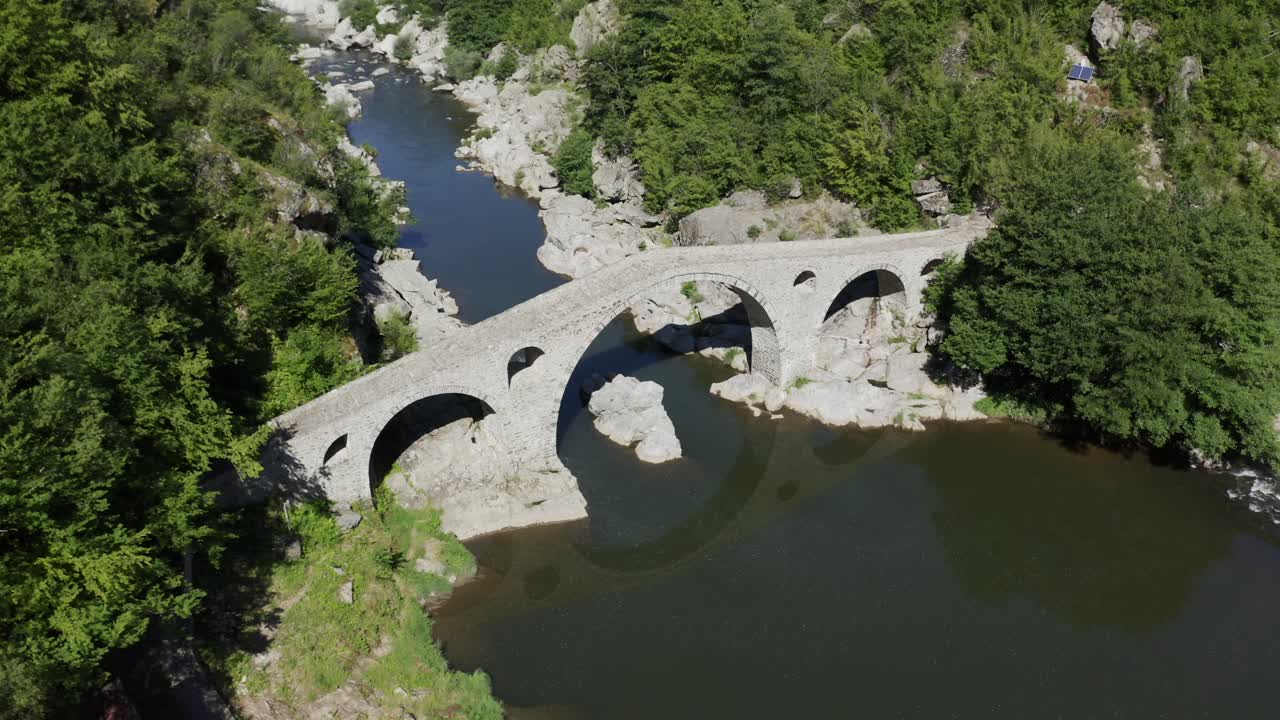 Drone panning from the left to the right side of the frame above the Devil's Bridge in the town of Ardino near the Rhodope Mountains in Bulgaria