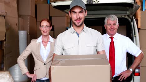 Delivery driver and business team smiling at camera