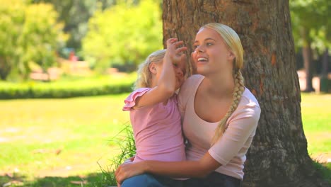 Young-girl-giving-a-flower-to-her-mother