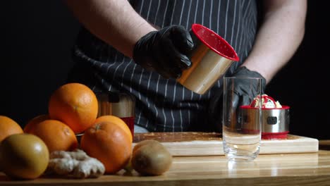 man pours freshly squeezed citrus fruit juice into glass