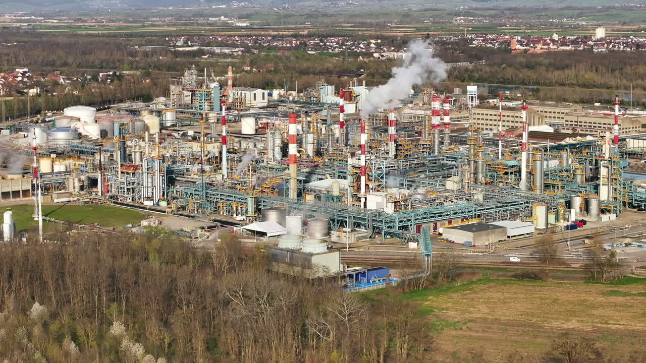 Alsachemie plant with active smokestacks, industrial complexity, daytime, aerial view