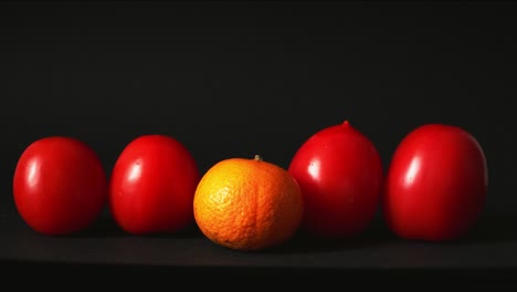 red fresh tomatoes on a black background