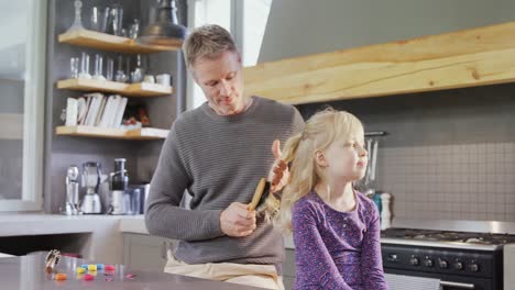 father brushing off daughters hair 4k