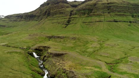 A-green-mountain-during-a-cloudy-and-windy-day-in-Iceland