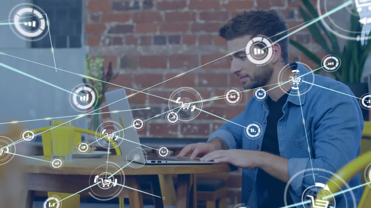 animación de una red de iconos digitales contra un hombre caucásico usando una computadora portátil en una cafetería