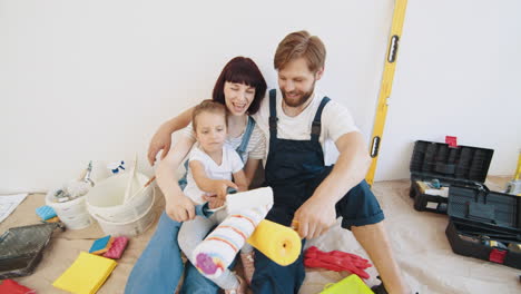 happy family painting a room together