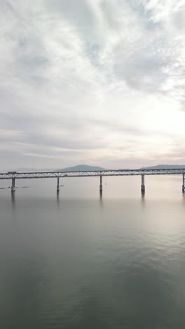 a sunset aerial shot highlights the richmond-san mateo bridge's impressive span, connecting richmond to san mateo.