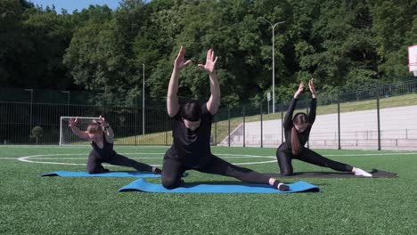 a group of women perform synchronized stretching exercises outdoors demonstrating their flexibility a group of women perform synchronized stretching exercises outdoors demonstrating their flexibility and fitness