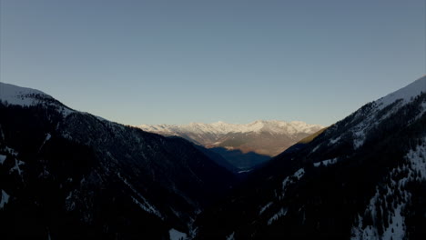 Aerial-View-Of-Dark-Forest-Covered-Stelvio-Pass-Mountain-Side