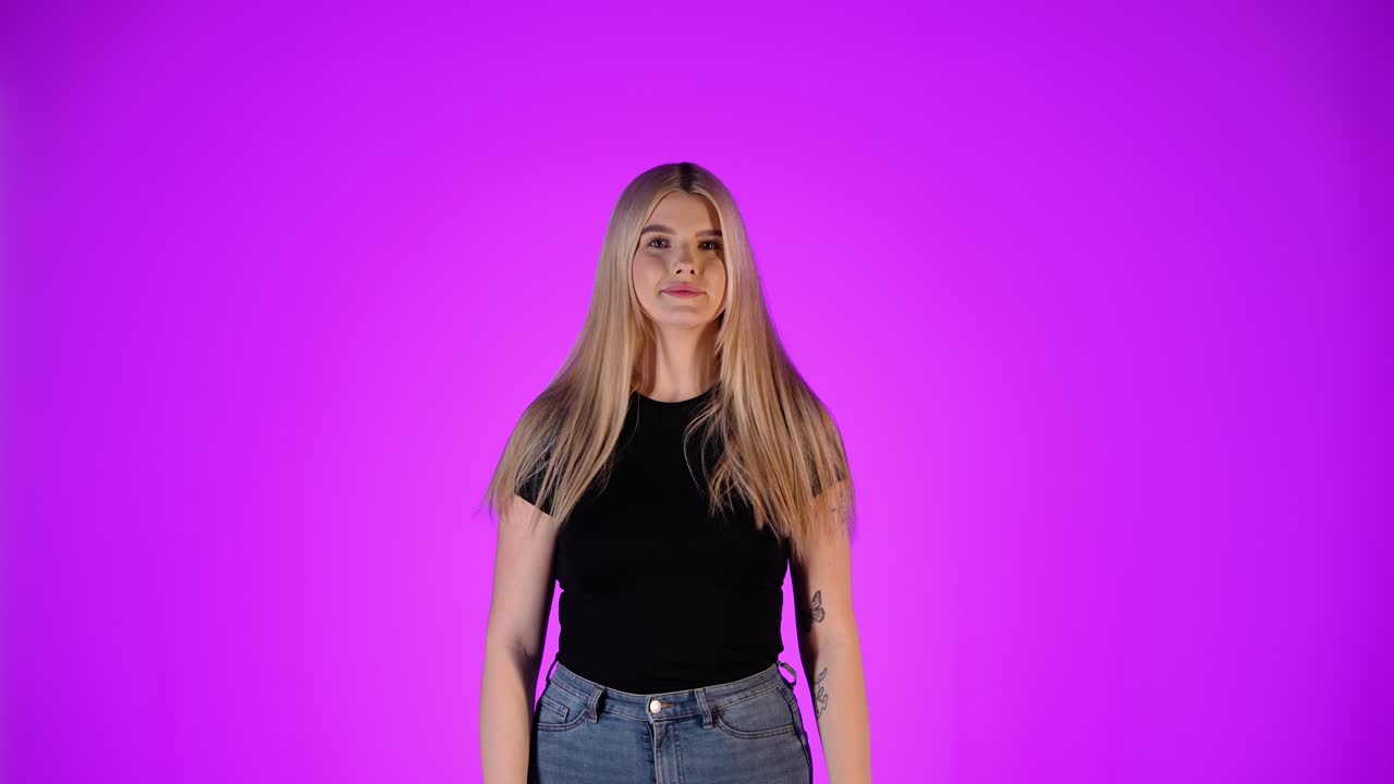 Smiling Blonde Woman in Black Shirt and Jeans