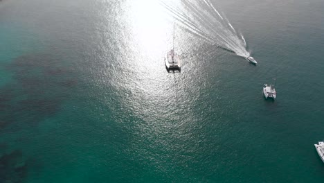 Aerial-view-of-boats-and-yachts-in-the-turquoise-waters-of-the-indian-ocean-around-La-Digue,-an-island-of-the-Seychelles