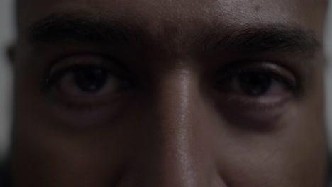 adult uk asian male looking directly at camera pensively