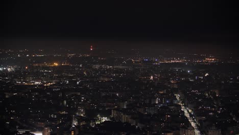 Milan-city-lights-at-night,-high-altitude-aerial-view