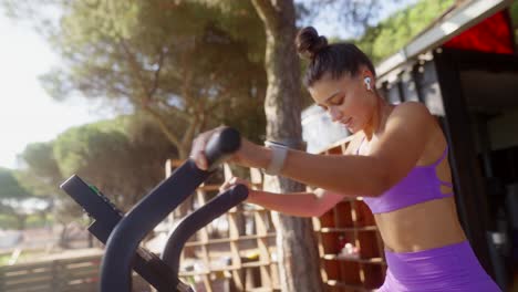 woman exercising outdoors on a fitness machine