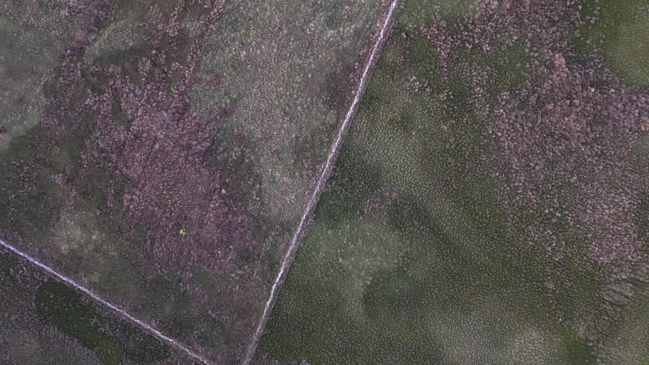 la antena mira directamente hacia abajo en la valla de piedra en el páramo escocés accidentado