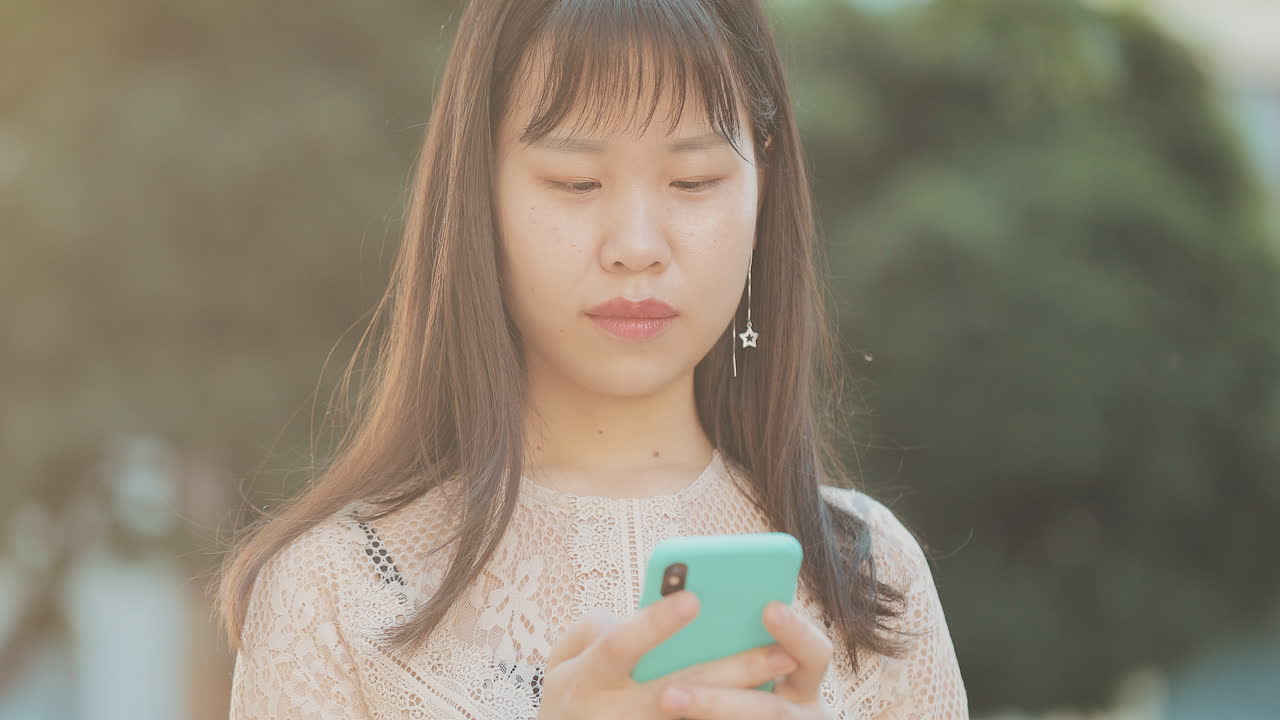 Asian woman using her phone