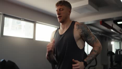 man running on a treadmill at the gym