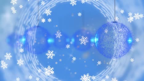 digital animation of snowflakes falling over multiple baubles hanging against blue background