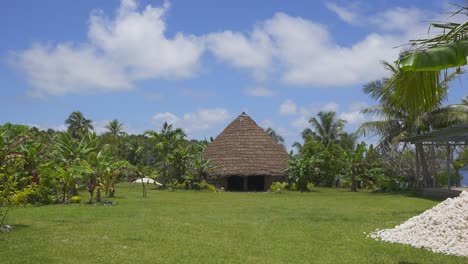 a traditional kanak house nestled within a lush and natural environment during the day