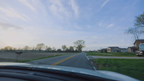 driving down road at sunset - view from passenger seat