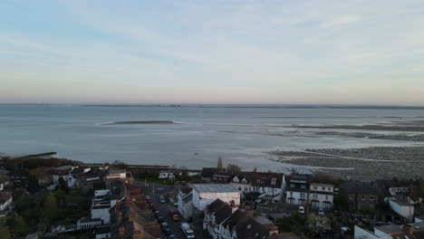 dusk aerial seascape shot. drone over sea. 4k stock video aerial view of sunset over water. sandy british seascape.
