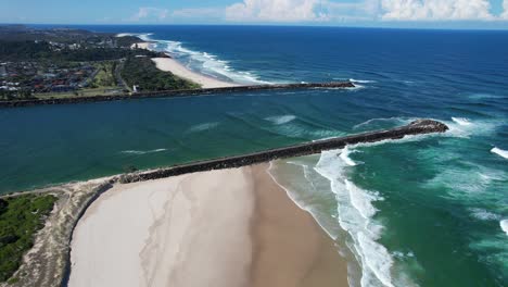 aerial view of waves coming to the shoreline of beaches in ballina - richmond river mouth in nsw, australia