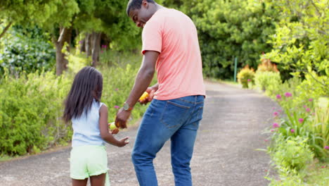 african american, father and daughter enjoying playful moment outdoors, sharing smiles and laughter