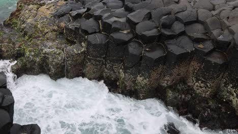 time-lapse of turbulent sea waves hitting rocky shore