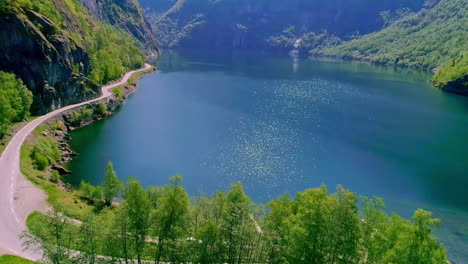 Drone-dolley-tilt-shot-of-sunlight-reflected-in-the-calm-Aurlandsfjord-in-Norway