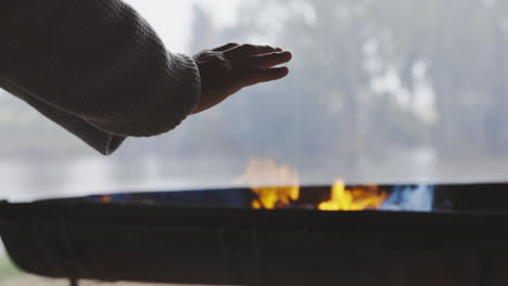 Hands,-camping-and-fire-with-a-person