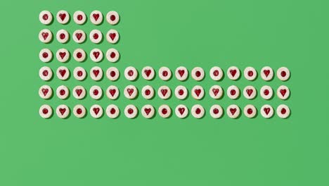 Animation-video-with-Linzer-cookies-on-a-green-background-view-from-above