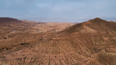 an aerial view of a desert landscape, with a top of a mountain at tataouine rotating