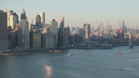 establishing shot of new york city. shot with a drone above the east river.