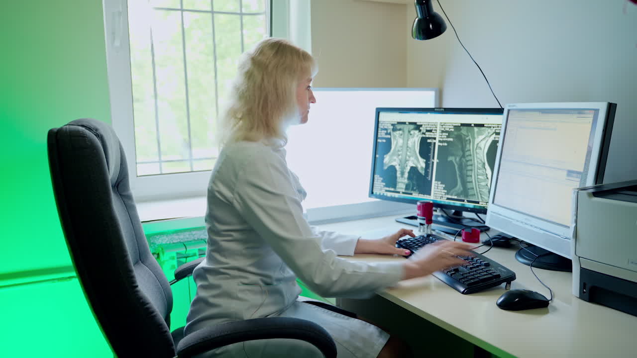 Physician In Front Of Computer. Medical research scientist typing on desktop computer