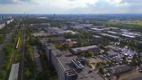 Unbelievable-aerial-top-view-flight-Yellow-suburban-train-S-Bahn-on-tracks,-Berlin-Marzahn-summer-2023