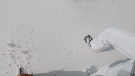 a man and a woman walking on a snowy winter mountain