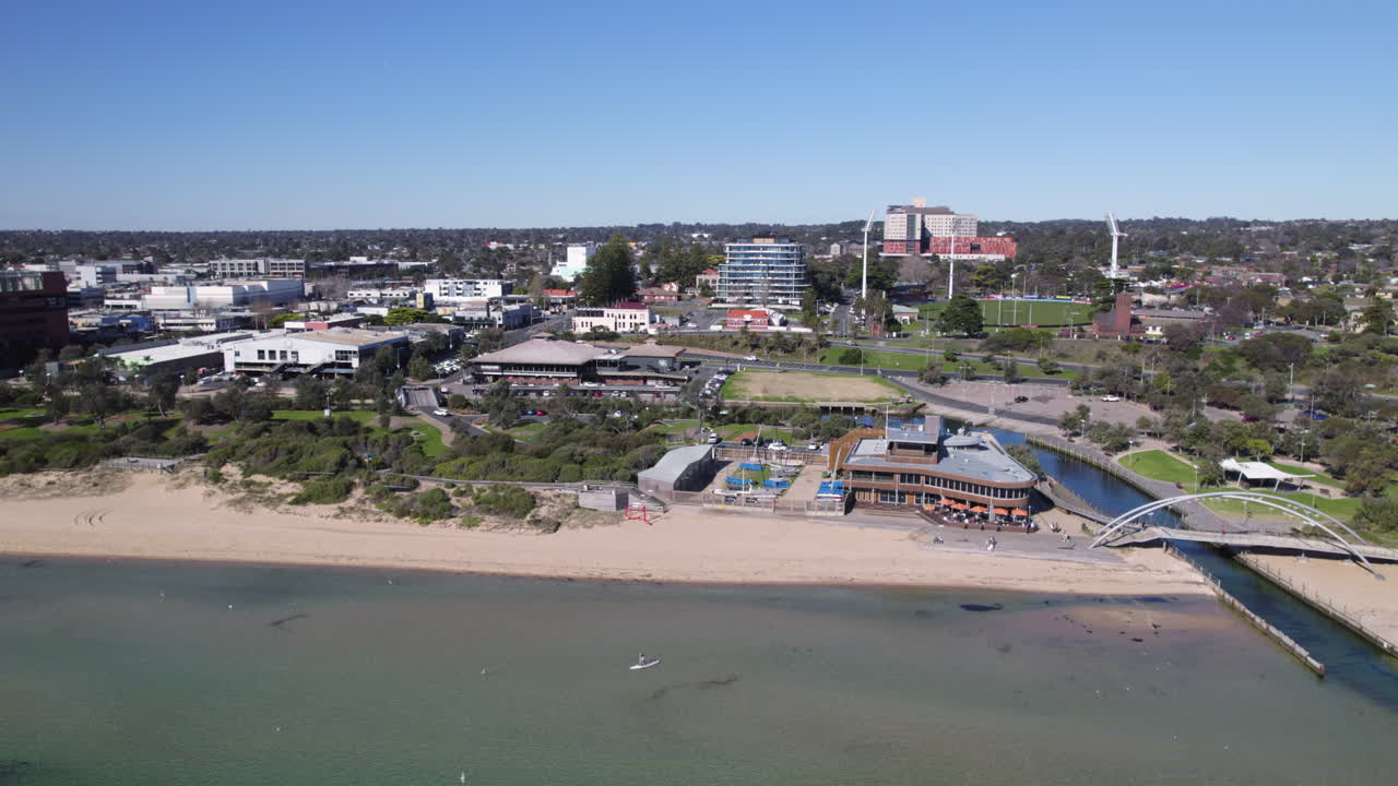 Drone tracking sideways along Frankston beach and village, Australia