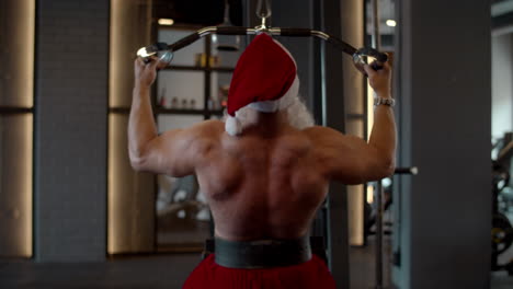 Active-santa-man-doing-bench-press-at-gym.-Sportsman-training-in-sport-club