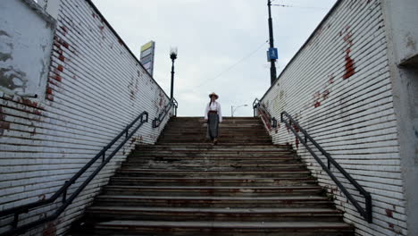 romanian girl descends into a old pedestrian passage 1