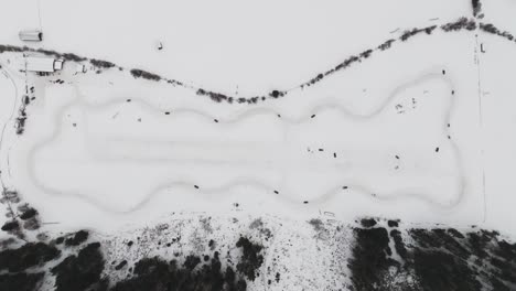 Vista-Aérea-De-Arriba-Hacia-Abajo-De-La-Pista-De-Carreras-De-Deriva-Invernal-En-Círculo-Completo-Con-Curvas