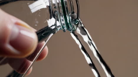 water pouring into a jar